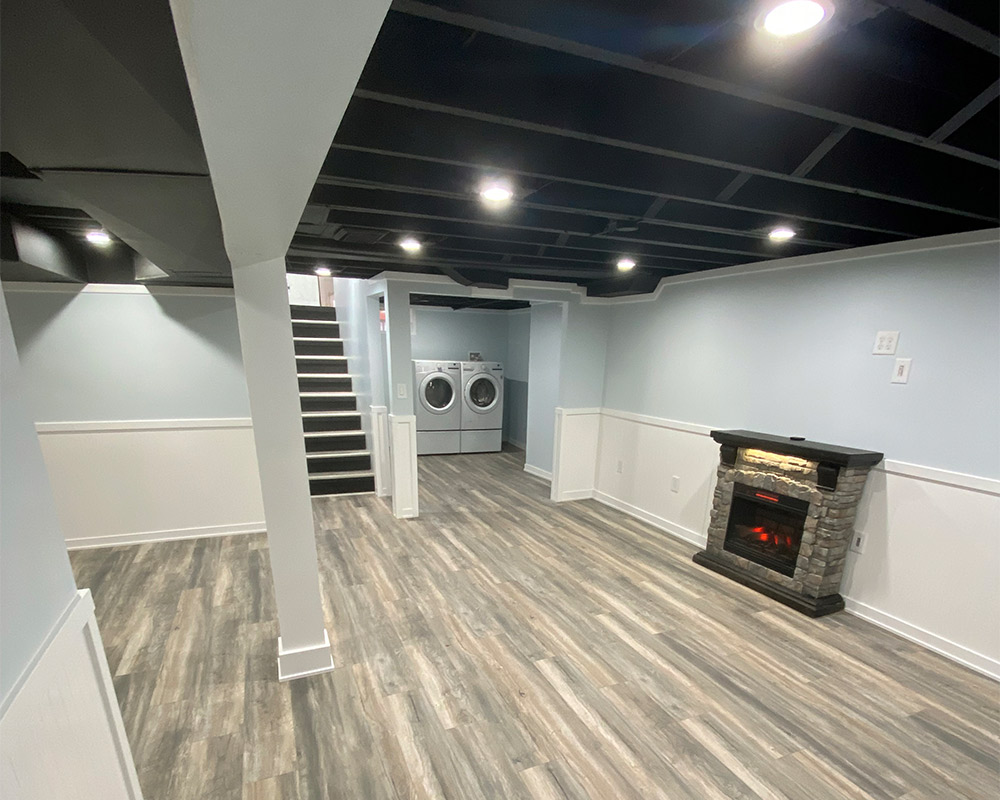 basement interiors remodeled with wooden floor and fireplace williamstone mi